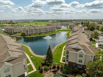 A large lake is surrounded by apartment buildings